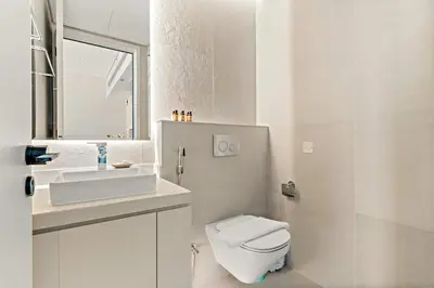 a white bathroom with a toilet and a sink at Silkhaus Luxury 1BR at Marina Star in Dubai Marina in Dubai