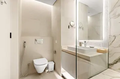 a white bathroom with a toilet and a sink at Silkhaus Luxury 1BR at Marina Star in Dubai Marina in Dubai