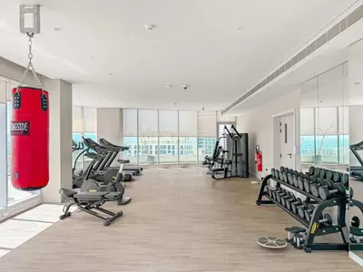 a gym with a lot of treadmills and machines at Silkhaus Luxury 1BR at Marina Star in Dubai Marina in Dubai