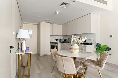 a kitchen and dining room with a table and chairs at Silkhaus Luxury 1BR at Marina Star in Dubai Marina in Dubai