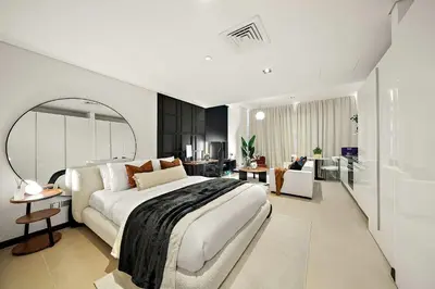 a bedroom with a large bed and a living room at Silkhaus Gamer's Dream Studio in Liberty House in Dubai