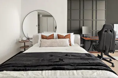 a bedroom with a bed and a desk and a chair at Silkhaus Gamer's Dream Studio in Liberty House in Dubai