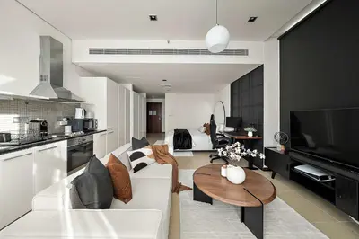 a living room with a white couch and a table at Silkhaus Gamer's Dream Studio in Liberty House in Dubai