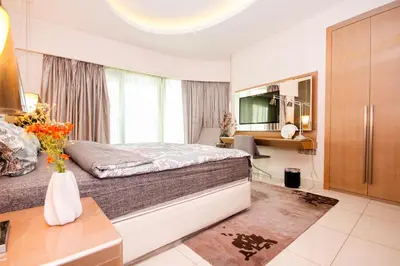a bedroom with a bed and a living room at Stay in Style at Paramount Towers Spacious 1BR High Floor Luxury Furniture Branded Amenties in Dubai