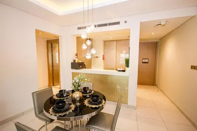 a dining room with a black table and chairs at Stay in Style at Paramount Towers Spacious 1BR High Floor Luxury Furniture Branded Amenties in Dubai
