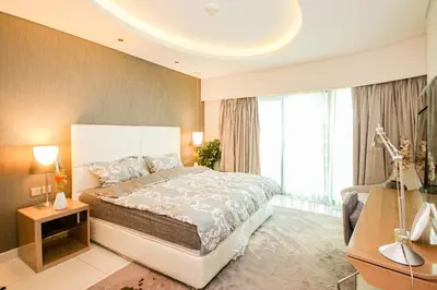 a bedroom with a large bed and a large window at Stay in Style at Paramount Towers Spacious 1BR High Floor Luxury Furniture Branded Amenties in Dubai