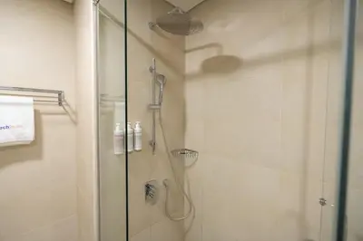 a shower with a glass door in a bathroom at Luxury 2BHK Sea & Palm Views 20th Floor Tram line in Dubai