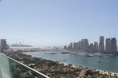 a view of a city with a river and buildings at Luxury 2BHK Sea & Palm Views 20th Floor Tram line in Dubai