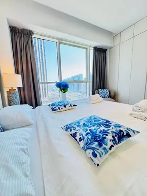 a bedroom with a large bed with a large window at One bedroom Apartment in Dubai Marina next to the Marina Mall in Dubai