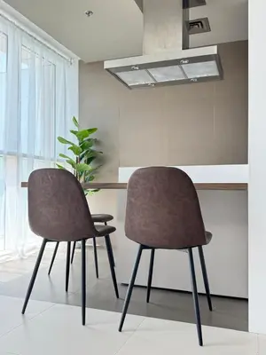 two chairs sitting next to a table in a kitchen at One bedroom Apartment in Dubai Marina next to the Marina Mall in Dubai