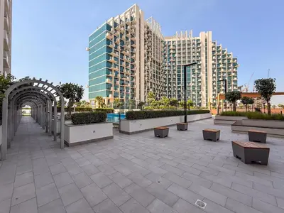 a courtyard with benches and buildings in a city at GuestReady - Furnished Studio | Burj & Canal Views in Dubai