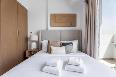 a bedroom with a large white bed with two pillows at GuestReady - Furnished Studio | Burj & Canal Views in Dubai