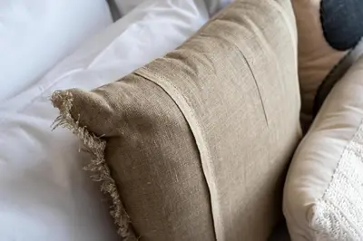 a rolled up pillow on a couch at GuestReady - Furnished Studio | Burj & Canal Views in Dubai