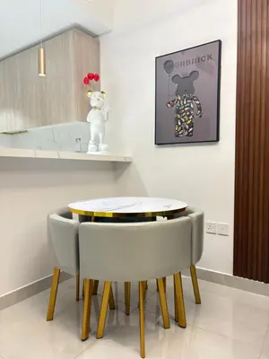 a kitchen with a table and two chairs at Spacious 1BR JVC Circle Mall at Your Doorstep in Dubai