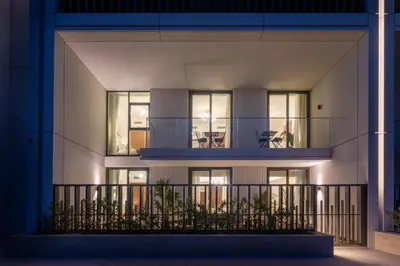 an apartment building with a balcony at night at Palace Residence Beach Villa - Direct Beach Access in Dubai