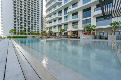 a swimming pool in front of a building at Palace Residence Beach Villa - Direct Beach Access in Dubai