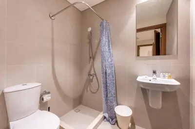 a bathroom with a toilet and a sink and a shower at Palace Residence Beach Villa - Direct Beach Access in Dubai