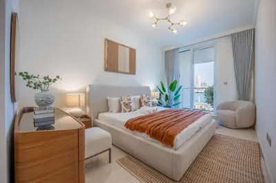 a bedroom with a king sized bed and a chair at Palace Residence Beach Villa - Direct Beach Access in Dubai