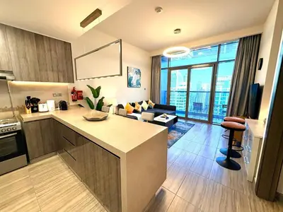 a kitchen and living room with a view of a living room at The Greendoor - Lake and Sea View, JLT in Dubai