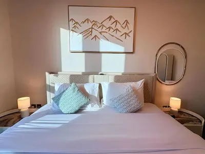 a bedroom with a bed with pillows and a mirror at The Greendoor - Lake and Sea View, JLT in Dubai