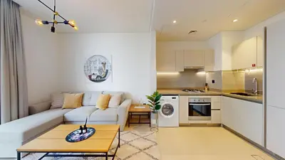 a living room with a couch and a table at Locations l Elegant One Bedroom l City Views and Free Pool, Gym Access in Dubai