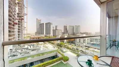 an apartment balcony with a view of a city at Locations l Elegant One Bedroom l City Views and Free Pool, Gym Access in Dubai
