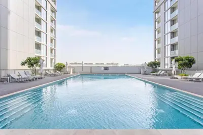 a swimming pool in the middle of a building at Locations l Elegant One Bedroom l City Views and Free Pool, Gym Access in Dubai