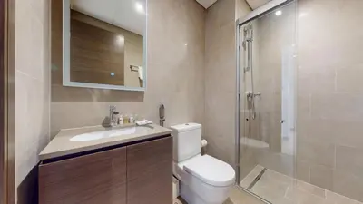 a bathroom with a toilet and a sink and a shower at Locations l Elegant One Bedroom l City Views and Free Pool, Gym Access in Dubai