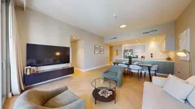 a living room with a couch and a table at Locations l Chic 3 Bedroom l Burj and Fountain Views l Downtown Dubai in Dubai
