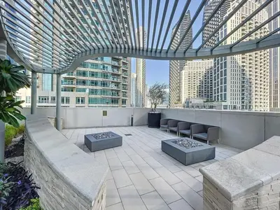 a rooftop patio with a view of a city at Locations l Chic 3 Bedroom l Burj and Fountain Views l Downtown Dubai in Dubai