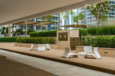 a row of white chairs sitting on a wooden deck at Branded 2BR in Nakhlat Jumeira - Palm View in Dubai