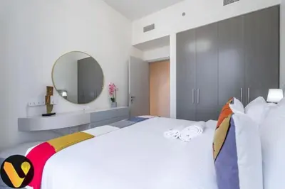 a bedroom with a large bed with a large mirror at Vogue Downtown Forte near Dubai Mall and Burj Khalifa, Three-Bedroom Plus Kids room with Balcony and Fountain view, full access to all amenities in Dubai