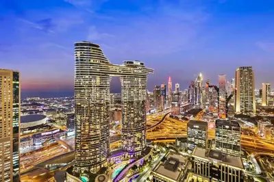 a view of a city skyline at night at Private room in 3BR Ultra-Luxury-High-Rise Apartment next to BURJ KHALIFA, DUBAI MALL in Dubai
