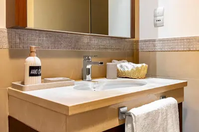 a bathroom counter with a sink and a mirror at Private room in 3BR Ultra-Luxury-High-Rise Apartment next to BURJ KHALIFA, DUBAI MALL in Dubai