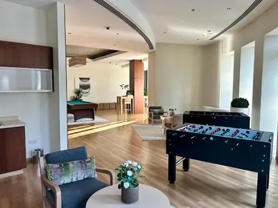 a living room with a foosball table in the middle at Private room in 3BR Ultra-Luxury-High-Rise Apartment next to BURJ KHALIFA, DUBAI MALL in Dubai