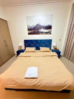 a large bed with a blue headboard in a room at Private room in 3BR Ultra-Luxury-High-Rise Apartment next to BURJ KHALIFA, DUBAI MALL in Dubai