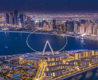 an aerial view of a city at night at Sansa Beach Home in Dubai