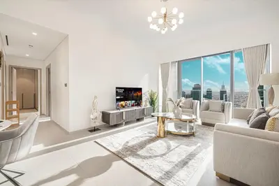 a living room with white furniture and a large window at Luxury Grande Suites by Hostiva - Full City View in Dubai