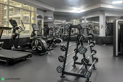 a gym with a bunch of treadms and machines at Clever Guest 031 Dubai Gate 2 in Dubai