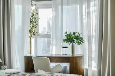 a table and chairs in a room with a window at Clever Guest 031 Dubai Gate 2 in Dubai