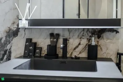 a bathroom counter with a sink with utensils at Clever Guest 031 Dubai Gate 2 in Dubai