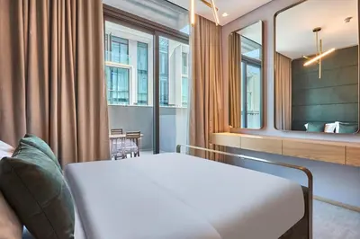a hotel room with a bed and a mirror at Luxury-Comfort & Elegance Studio in Dubai