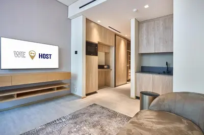 a living room with a tv on a wall at Luxury-Comfort & Elegance Studio in Dubai