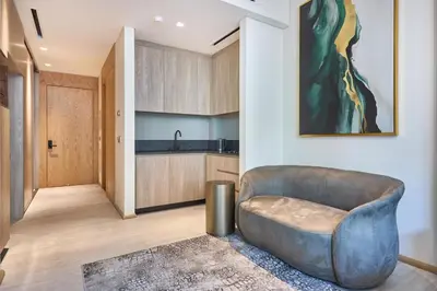 a living room with a couch and a kitchen at Luxury-Comfort & Elegance Studio in Dubai