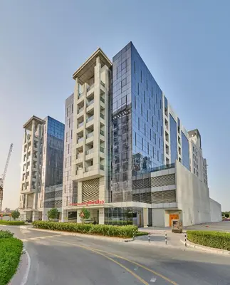 a large building with a road in front of it at Grand Stay Holiday Homes Rental 2 in Dubai