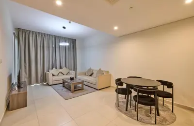 a living room with a table and a couch at Grand Stay Holiday Homes Rental 2 in Dubai