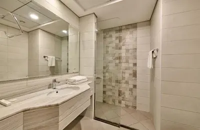 a bathroom with a sink and a shower at Grand Stay Holiday Homes Rental 2 in Dubai