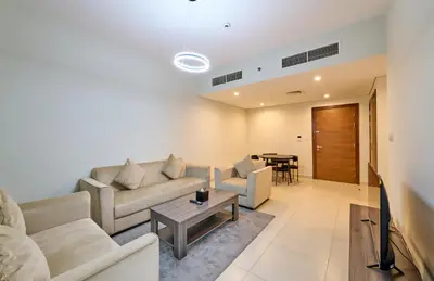 a living room with a couch and a table at Grand Stay Holiday Homes Rental 2 in Dubai