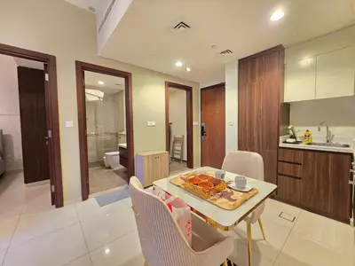 a kitchen and dining room with a table with food on it at 2BhK Big Balcony&Canal View Waterfront dubai mall in Dubai