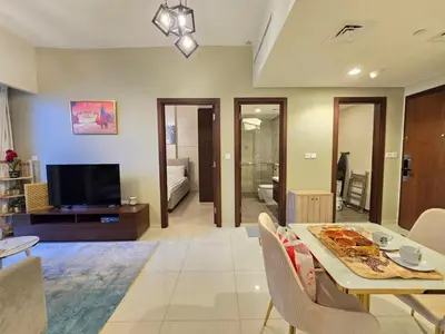 a living room with a dining table and a television at 2BhK Big Balcony&Canal View Waterfront dubai mall in Dubai